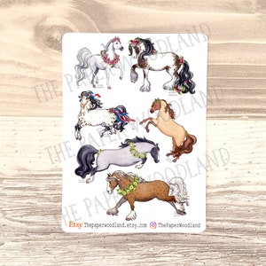 May include: A sticker sheet with illustrations of six horses, each decorated with flowers. The horses are depicted in different colours, such as white, brown, and grey, and wear floral crowns and ribbons. The Etsy shop name and social media handle are at the bottom.