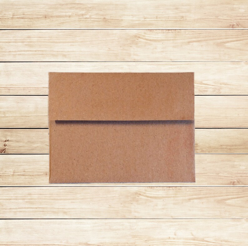 May include: A brown paper envelope on a light wood background.