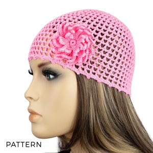 May include: A pink crocheted beanie with a pink crocheted flower on the side. The beanie is made with a loose stitch and has a scalloped edge.