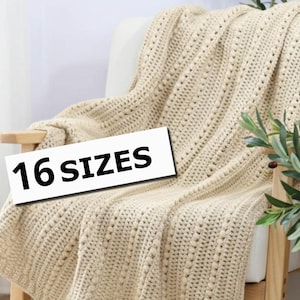 May include: A beige knitted throw blanket draped over a wooden chair. The blanket has a textured pattern and is folded to cover the chair. The text "16 SIZES" is displayed on a white rectangle in the image.