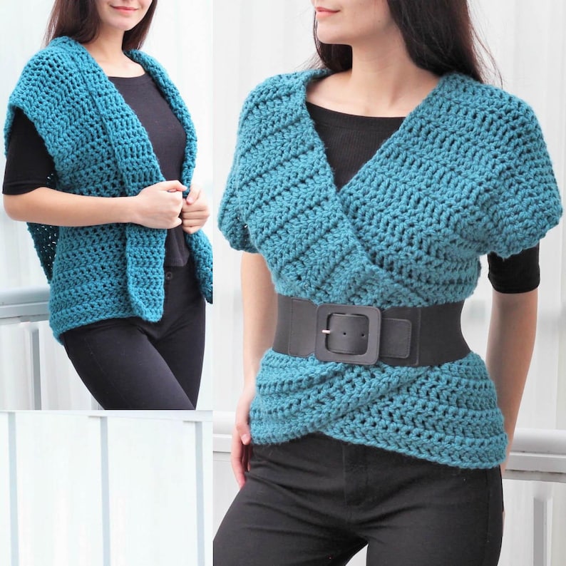 May include: A teal crochet wrap top featuring a textured stitch pattern, short sleeves, and a V-neckline. The garment is styled with a wide black belt with a rectangular buckle, worn over a black short-sleeved shirt and black pants.