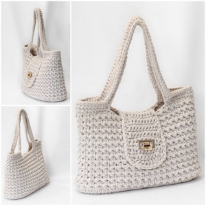 Puede incluir: Un bolso tote de crochet de color crema con cierre de solapa y cierre dorado. El bolso tiene dos asas largas.