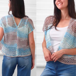 May include: A short-sleeved crochet cardigan featuring an open-knit mesh pattern with a variegated color palette of light blue, white, and soft brown. The garment has a V-neckline and a straight hem, showcasing a lightweight, semi-sheer construction.