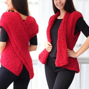 May include: A red knitted vest with a criss-cross back design. The vest is sleeveless and has a wide, open neckline.