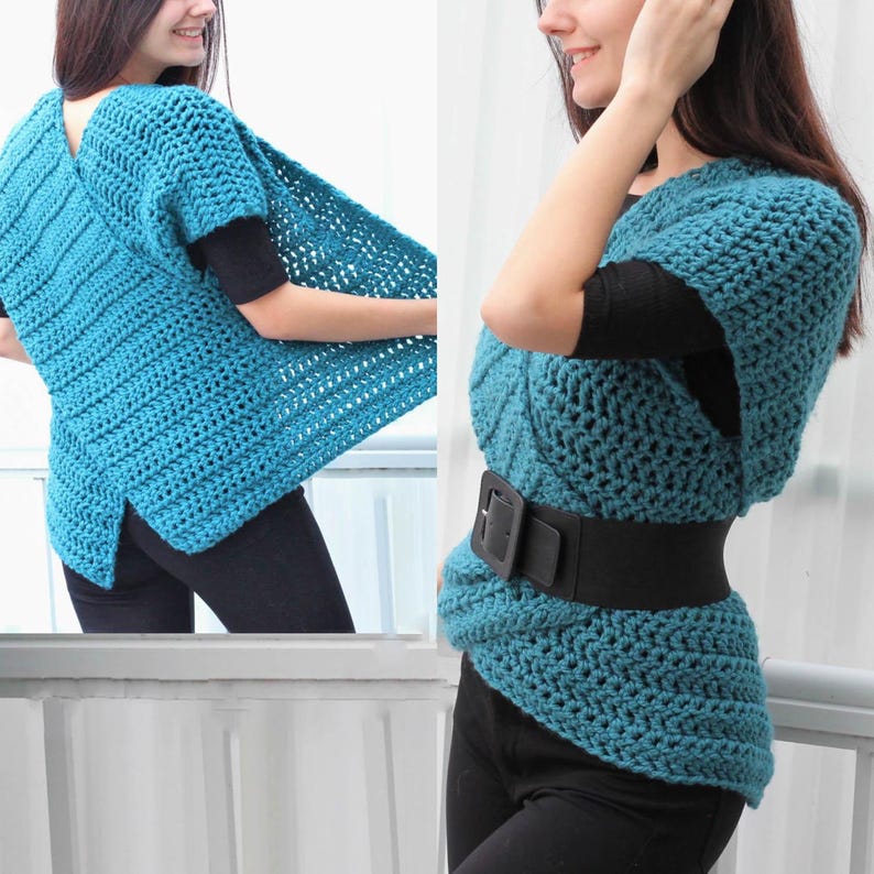May include: A teal crochet vest featuring a thick, textured knit pattern with short sleeves and a wrap-style front. The garment is cinched at the waist with a wide black belt that has a large rectangular buckle, layered over a black shirt and pants.