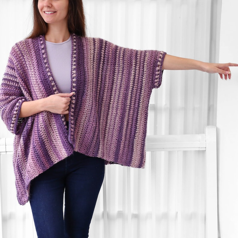 May include: A purple and pink striped crochet cardigan with a loose fit and a long, open front.