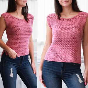 May include: A pink crochet top with a scoop neck and sleeveless design. The top is made with a simple stitch pattern and has a relaxed fit.