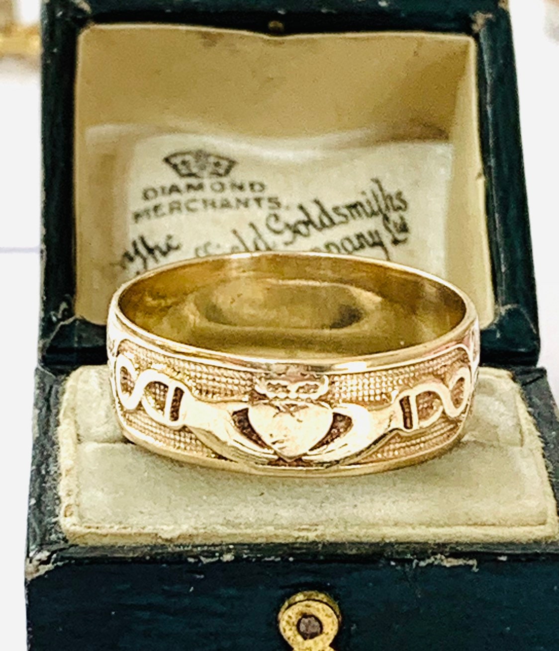 Two hands holding a hotsell heart with a crown