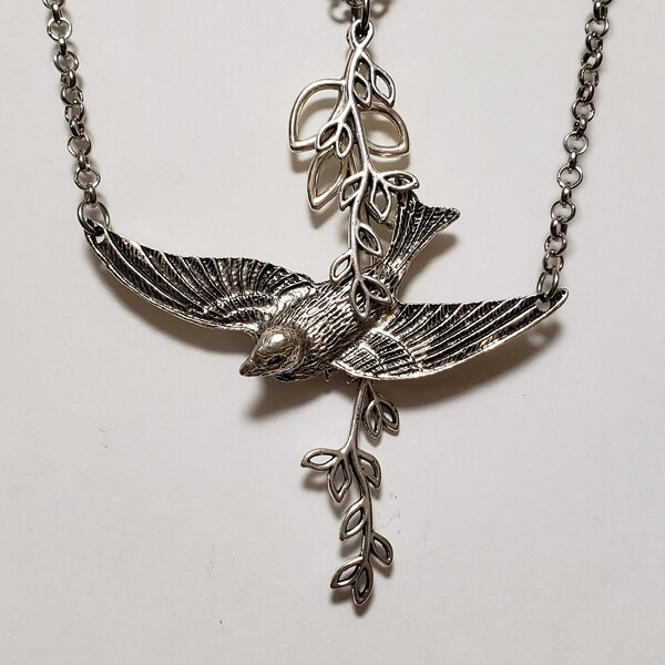 Free Bird Necklace - has 2 necklaces - 1 with Bird, and with 2 tree limbs and leaves - Plus a Free Pair of  Earrings