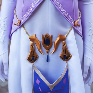 May include: A white and purple costume with a gold and blue decorative belt. The belt has a blue gem in the centre and two gold horns on either side.