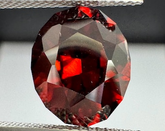 Unheated red Zircon. 6.95ct Mozambique oval. Precision cut.