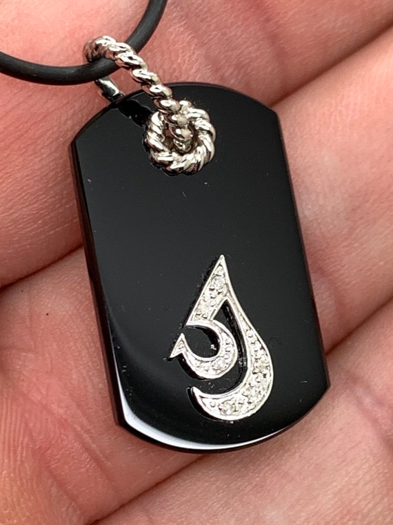 Dog tag style necklace. 14k gold accents with leather cord. 18 inch.
