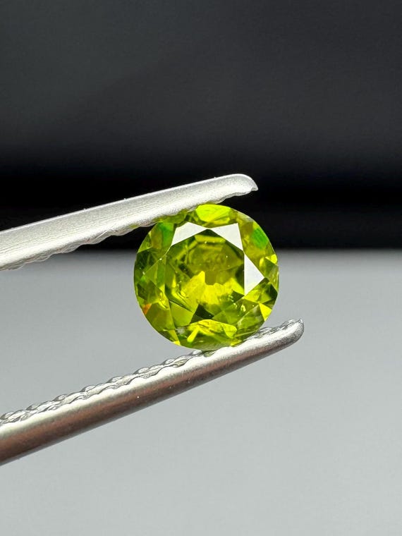 Russian Demantoid Garnet. Horsetail inclusions. 4.28mm Old European cut