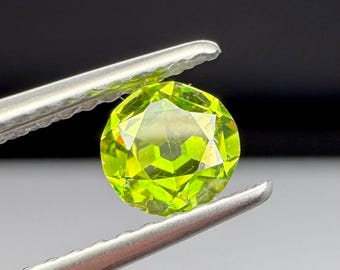 Russian Demantoid Garnet. 4.7mm horsetail inclusions. Old European cut.