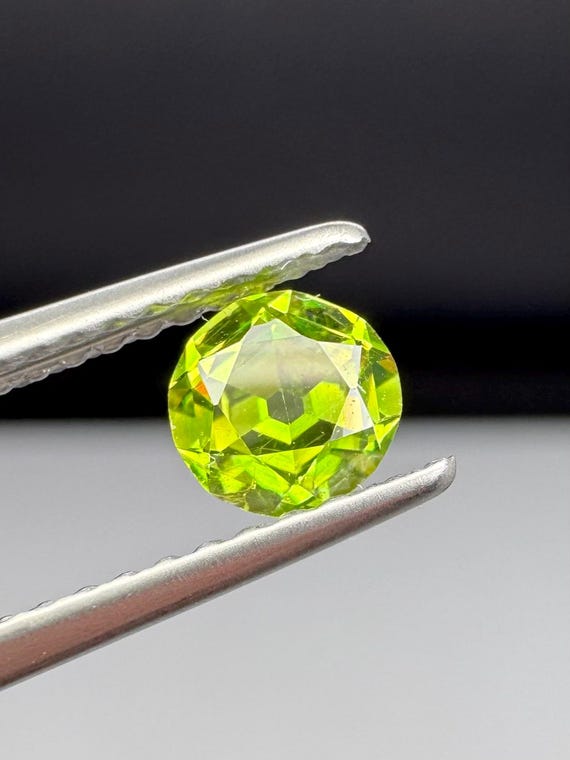 Russian Demantoid Garnet. 4.7mm horsetail inclusions. Old European cut.