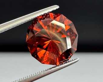 Zircon, precision cut 6.2ct Red/orange round. 10mm