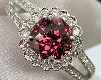 Precision cut Umbalite Garnet in designer setting. 18k white gold with natural diamond accents.