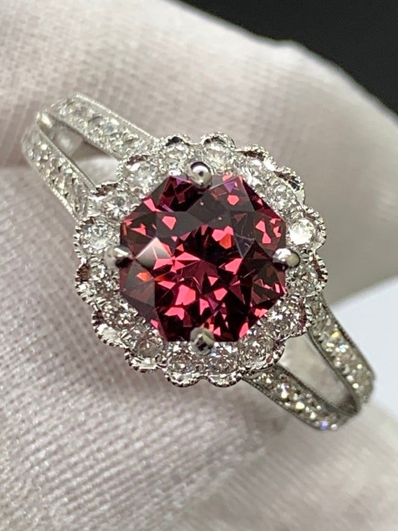 Precision cut Umbalite Garnet in designer setting. 18k white gold with natural diamond accents.