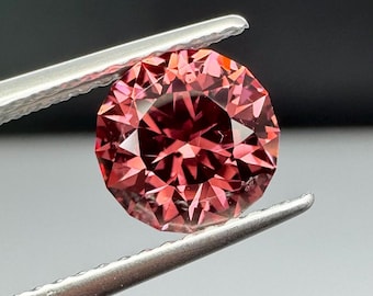 Round Spinel 7mm precision cut. Reddish, pink.