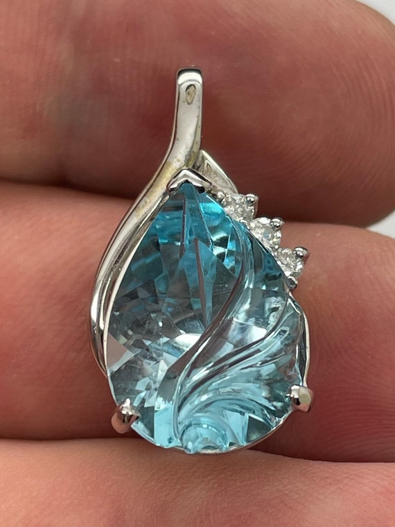 Fantasy cut blue topaz in 14k white gold. Natural Diamond accents. 25x14mm