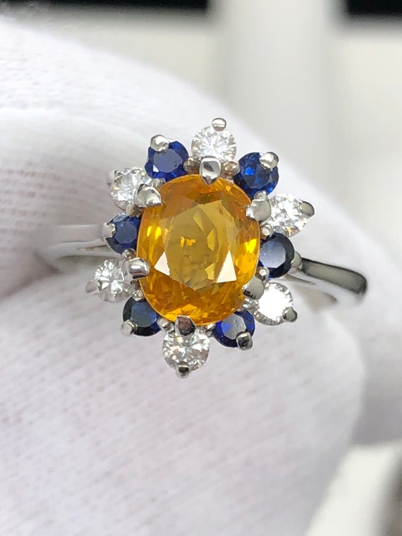 Yellow Sapphire in platinum setting.Natural diamond and Sapphire accents. Size 5.