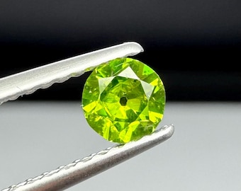 Russian Demantoid Garnet with horsetail inclusions. 4.14mm Old European Cut