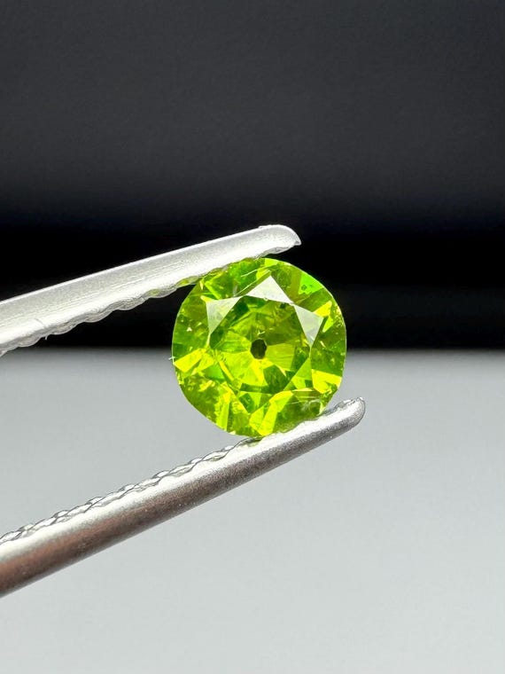 Russian Demantoid Garnet with horsetail inclusions. 4.14mm Old European Cut
