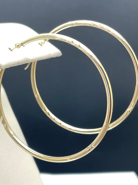 45mm large, yellow gold hoops. 14k etched gold design.