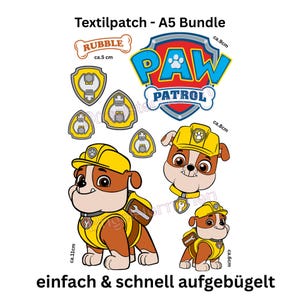 Könnte beinhalten: Ein A5-Bundle mit Bügelflicken mit Charakteren und Logos aus der Zeichentrickserie Paw Patrol. Die Patches enthalten das Paw Patrol-Logo, die Figur Rubble und verschiedene Schilddesigns. Der Text "Textilpatch - A5 Bundle" und "einfach & schnell aufgebügelt" sind ebenfalls sichtbar.