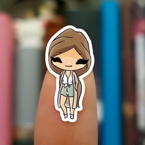 May include: A cartoon illustration of a girl with brown hair wearing a white shirt, green shorts, and a brown cardigan. She is smiling and has her arms at her sides.