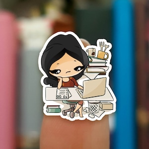 May include: A cartoon illustration of a person sitting at a desk with a laptop, a cup of coffee, and a stack of books. The person is wearing a red shirt and has black hair. The desk is cluttered with papers and other items.