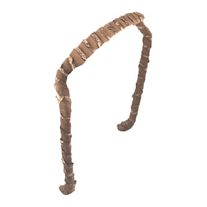 May include: A brown headband with a textured, woven design. The headband is made of a soft, flexible material and is perfect for adding a touch of style to any outfit.