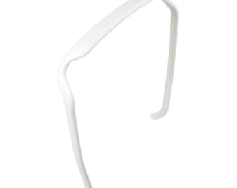 May include: A white plastic headband for hair.