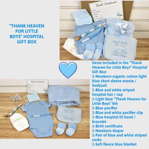 May include: A blue and white hospital gift box for a newborn baby boy. The box includes a light blue onesie, a blue and white striped hat, a blue bib with the text "Thank Heaven for Little Boys", a blue pacifier, a blue and white pacifier clip, a blue hospital ID band, a blue blanket, a blue diaper, and a birth certificate.