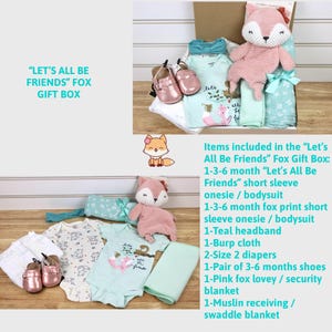 May include: A gift box filled with baby items for a newborn, including a pink fox plush toy, a teal headband, a burp cloth, two diapers, a pair of shoes, a pink fox lovey, and two onesies. The box is labeled "Let's All Be Friends" Fox Gift Box.