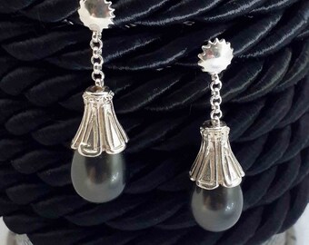 Charming  sterling silver handmade earrings enhanced with black pearls .