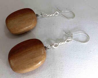 Adorable sterling silver earrings adorned with wood bead .