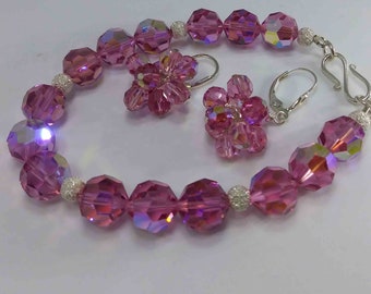 Swarovski bracelet and earrings . Color shiny pink  .