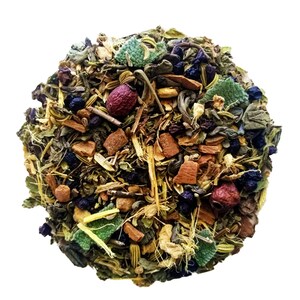 May include: A close-up view of a circular blend of dried herbs and botanicals. The mix includes green leaves, small dark berries, reddish-brown pieces, and other colorful elements. The arrangement suggests a loose-leaf tea blend, with a variety of textures and colors.