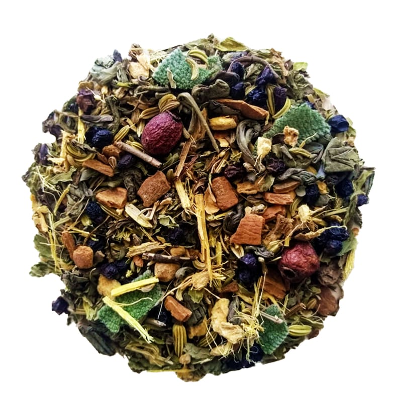May include: A close-up view of a circular blend of dried herbs and botanicals. The mix includes green leaves, small dark berries, reddish-brown pieces, and other colorful elements. The arrangement suggests a loose-leaf tea blend, with a variety of textures and colors.