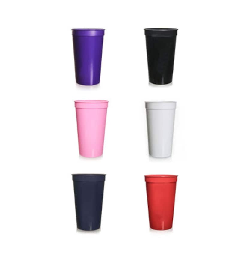 May include: Six plastic cups in different colors: purple, black, pink, white, navy blue, and red. The cups are all the same size and shape.