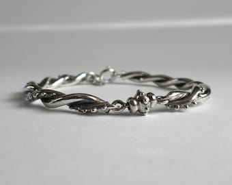 Sterling silver bracelet, handmade bracelet, interlaced bracelet, intertwined bracelet, polished and oxidized bracelet, swarovski crystals.