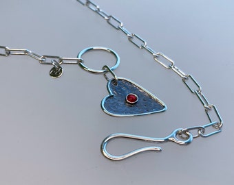 Sterling silver 925 necklace link chain with a heart pendant with a "cat eye" stone and a polished/oxidized finish.