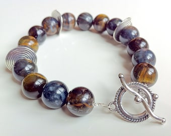 Bracelet with hawk's eye stones and sterling silver spiral trinkets