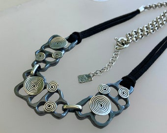 Leather and sterling silver necklace with scratched oxidized finish and polished spirals