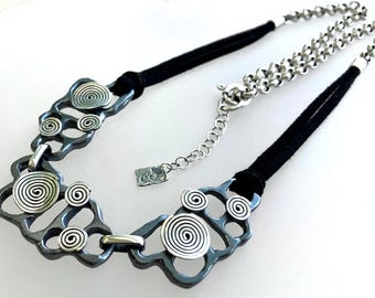 Leather and sterling silver necklace with scratched oxidized finish and polished spirals