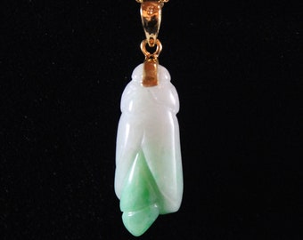 May include: A jade pendant in the shape of a cicada, carved from white and green jade, with a gold chain.