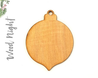 May include: A plain, unfinished wooden ornament shaped like a Christmas tree bauble. The ornament is light brown and has a hole at the top for hanging.