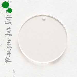 May include: A clear round acrylic ornament with a hole at the top for hanging.