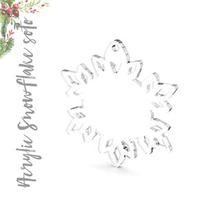 May include: A clear acrylic snowflake ornament with a hole at the top for hanging.